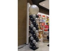 Tall balloon column of silver and black balloons.
